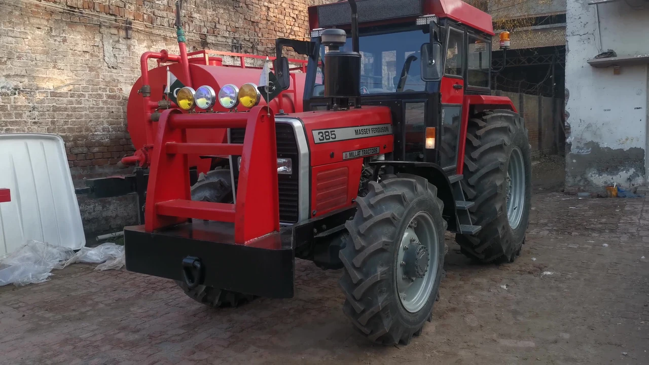 Wide archive-video frame of a red MF 385 tractor with an enclosed cabin