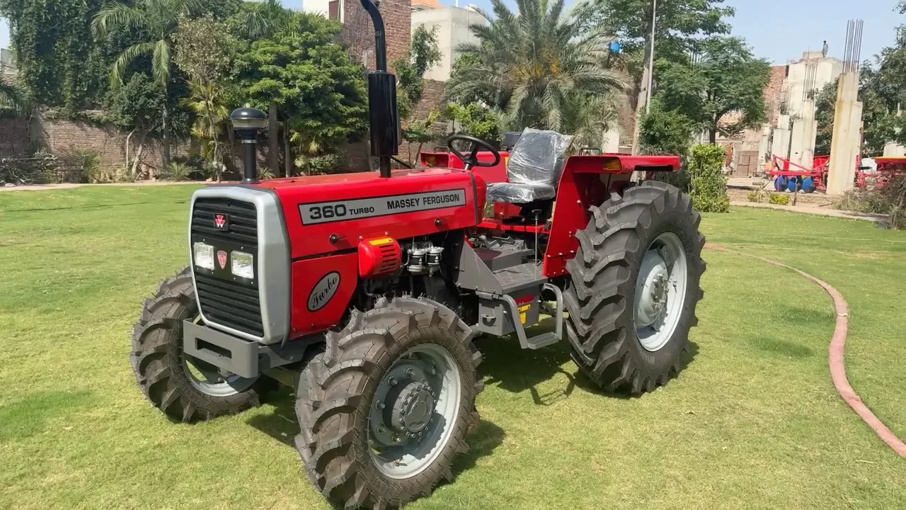 Red tractor photographed from the front left on a lawn